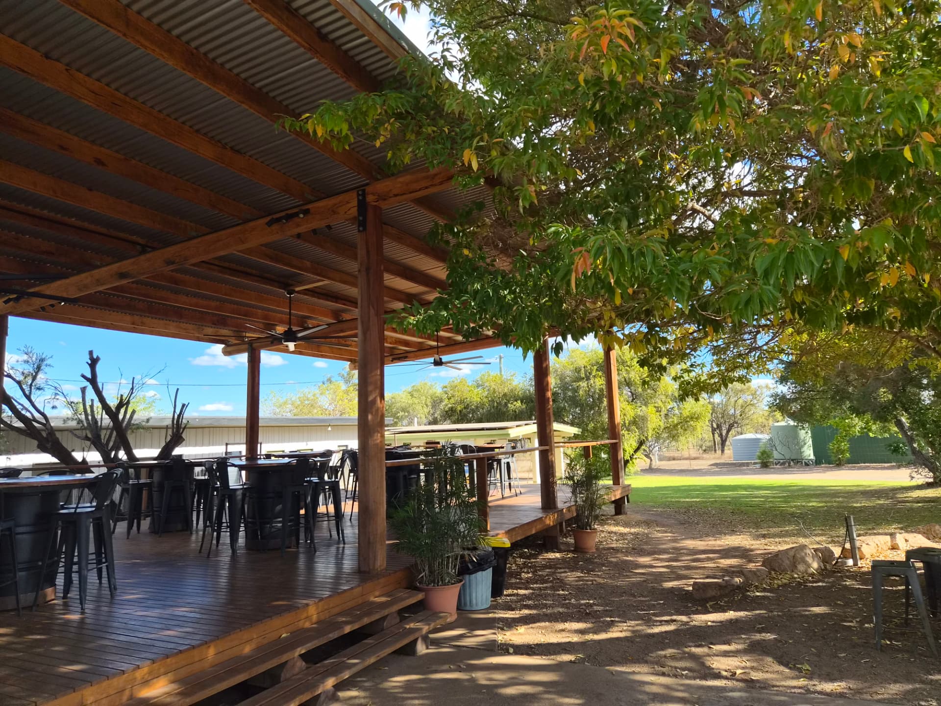 The covered deck and lawn on a clear day